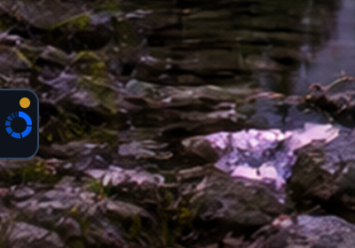 The real OpenLimiter edge tab, a small tab with the OpenLimiter logo and a yellow dot, on the left edge of a desktop with a mountain lake wallpaper.